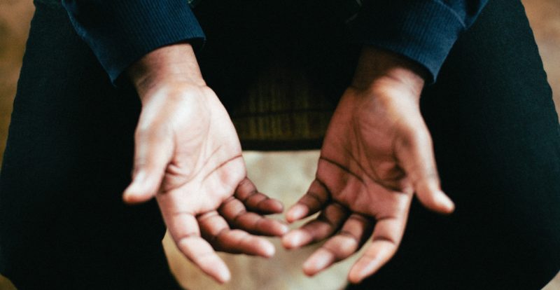 person showing both palms while sitting on chair